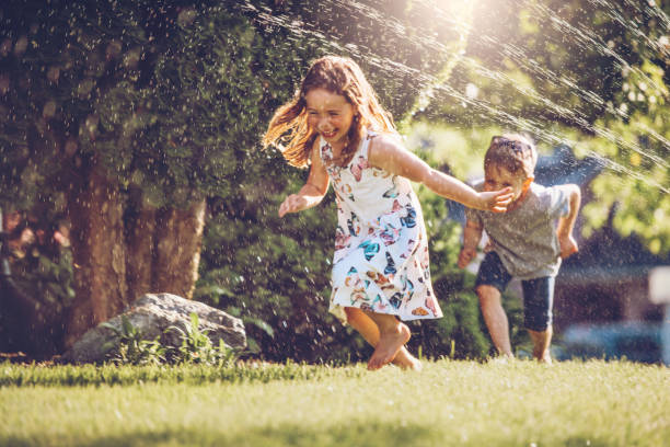 Kids playing with sprinkler