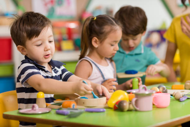 Childs are playing with play clay in classroom in schools fenton