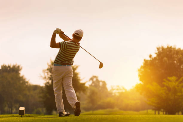 Golfers hit sweeping golf course in the summer