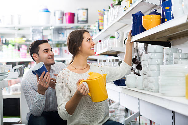 Happy adult couple buying ceramic ware in the shop