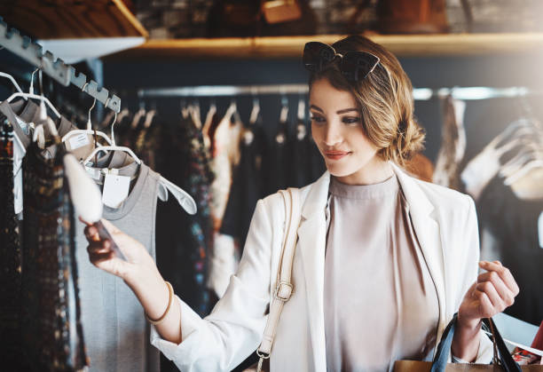 Shot of a young woman looking at a few items in a boutique