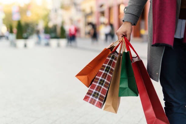 Man holding bags with presents on the street