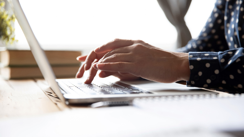 Female hands of business woman professional student using laptop sit at home office desk typing on computer keyboard study work with pc software tech concept, online job and education, close up view