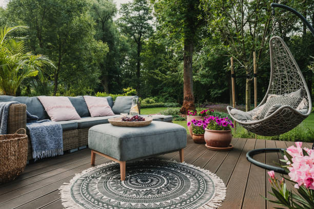 Garden patio decorated with Scandinavian wicker sofa and coffee table home furnishings