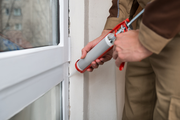 Person Applying Silicone Sealant