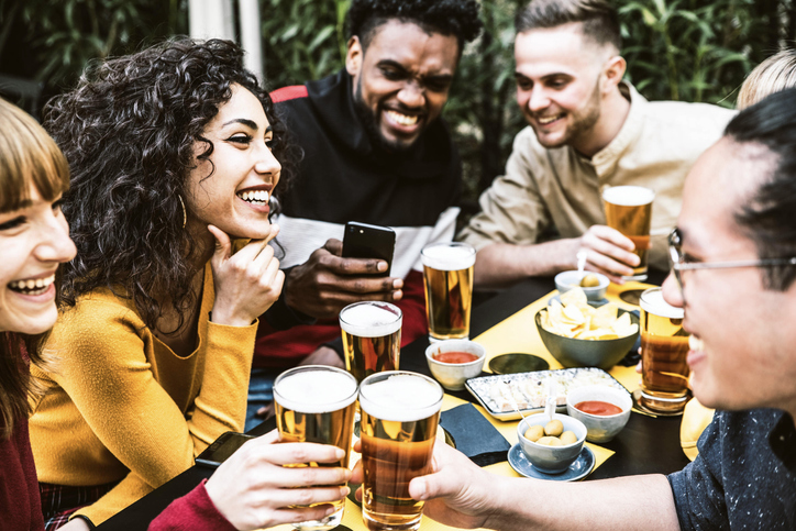 Happy diverse friends drinking beer