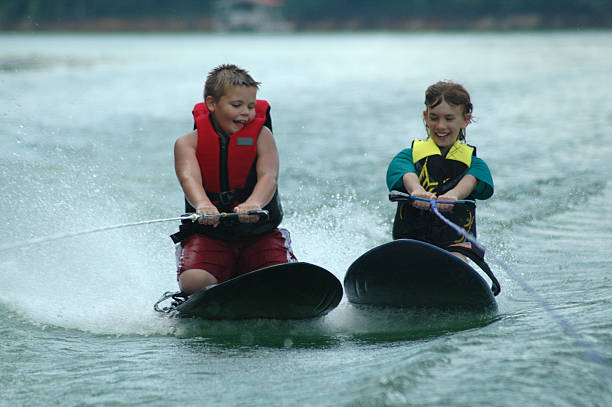 Two cousins kneeboarding during summer vacation.